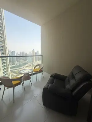 a living room with a couch and a table and chairs at Samani vacation homes 4906 canal view in Dubai