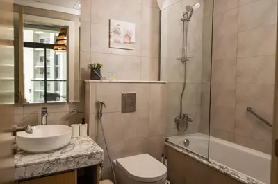 a bathroom with a sink and a toilet and a shower at Samani vacation homes 4906 canal view in Dubai