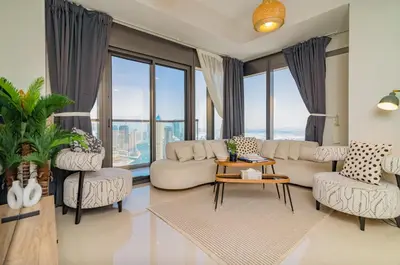a living room with a couch and chairs and windows at Samani vacation homes 5210 ocean view in Dubai