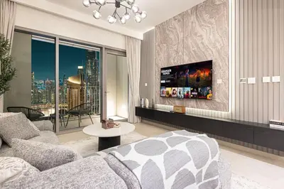 a living room with a couch and a tv at Mahogany 14 - 2BR Dubai Mall Walk & Burj Khalifa in Dubai