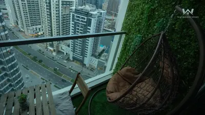 a hammock in a room with a view of a city at Elevated Living Studio Facing the Burj in Dubai