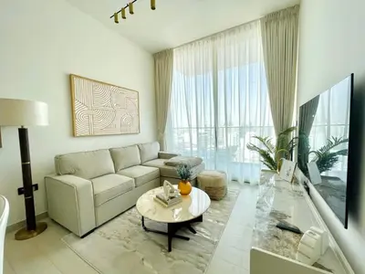 a living room with a couch and a table at Opulent Nook 1br Designer Hideaway In Onyx in Dubai