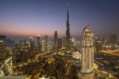 a view of a large city at night at Downtown Dubai 3BR Burj Royale in Dubai