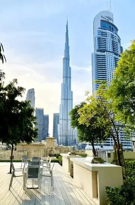 a view of a city skyline with chairs and buildings at Downtown Dubai 3BR Burj Royale in Dubai