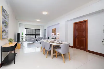 a dining room and living room with a table and chairs at Golden Mile at its Best 2BR Plus Maids Palm Jumeirah in Dubai