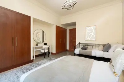 a bedroom with a bed and a desk with a mirror at Golden Mile at its Best 2BR Plus Maids Palm Jumeirah in Dubai