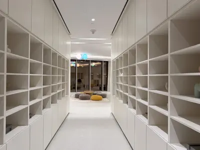 a hallway with white shelving in a building at Sky-High Burj Khalifa and Fountain Views in Dubai