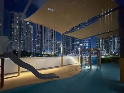 a balcony with a view of a city at night at Sky-High Burj Khalifa and Fountain Views in Dubai