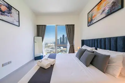 a bedroom with a large bed with a view of the city at Sky-High Burj Khalifa and Fountain Views in Dubai