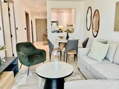 a living room with a couch and a table at Comfortable 1br In Jvc Balcony Free Parking in Dubai