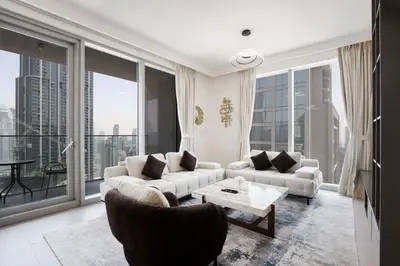 a living room with couches and a table and large windows at Upgraded 3BR plus Maid's near Burj Khalifa & Dubai Opera in Dubai