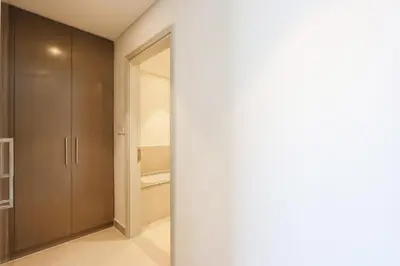 a room with a closet and a door to a bathroom at Upgraded 3BR plus Maid's near Burj Khalifa & Dubai Opera in Dubai