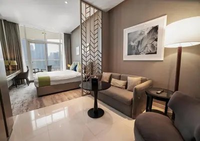 a living room with a couch and a bed at Stunning Canal View with Balcony in Dubai