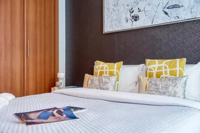 a bedroom with a bed with a picture on it at The Smart Concierge - Dorra Bay in Dubai