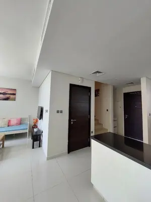 a kitchen and living room with a black counter top at Damac Hills 2- Relaxing 3BR townhouse - Homeyvillas in Dubai