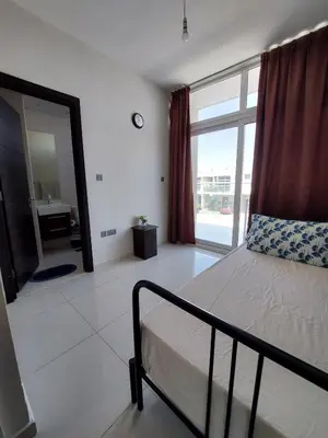 a bedroom with a bed and a bathroom with a mirror at Damac Hills 2- Relaxing 3BR townhouse - Homeyvillas in Dubai
