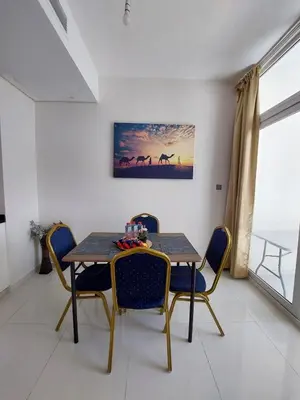 a dining room with a table and chairs at Damac Hills 2- Relaxing 3BR townhouse - Homeyvillas in Dubai