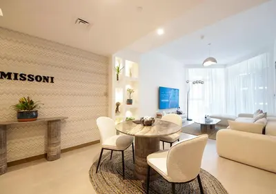 a living room with a table and chairs at Luxury 2BR in Urban Oasis by Missoni on High Floor in Dubai