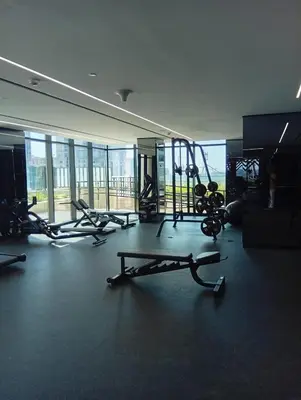a gym with treadmills and machines in a room at Luxury 2BR in Urban Oasis by Missoni on High Floor in Dubai