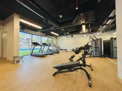 a gym with several exercise bikes in a room at Vserve - Peaceful 1 BR Getaway in Vibrant JVC in Dubai