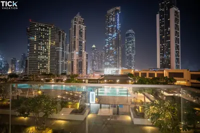 a view of a city skyline at night at Burj Crown Luxury 2BR W Balcony & Pool View 8th Floor in Dubai
