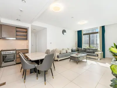 a kitchen and living room with a table and chairs at Burj Crown Luxury 2BR W Balcony & Pool View 8th Floor in Dubai