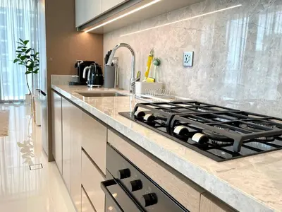 a kitchen with a stove and a sink at Elegant & Luxurious 1BR Apartment in Beach Isle in Dubai