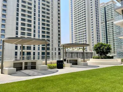 two picnic shelters in a park with tall buildings at Elegant & Luxurious 1BR Apartment in Beach Isle in Dubai