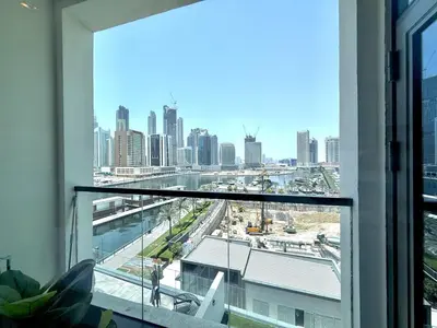a view of a city skyline from a window at Vserve - 1 BR Escape With City Views & Canal Vibes in Dubai