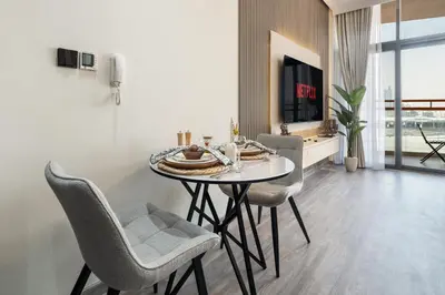 a dining room with a table and chairs at Trendy Studio Apartment in Binghatti Crystals in Dubai