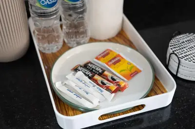 a lunch box with toothbrushes and toothpaste at Trendy Studio Apartment in Binghatti Crystals in Dubai