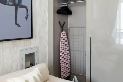 a living room with a surfboard hanging on the wall at Trendy Studio Apartment in Binghatti Crystals in Dubai