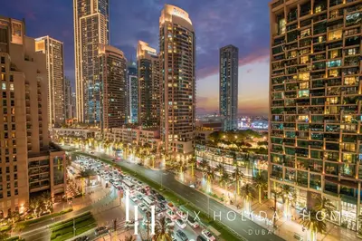 a city skyline with tall buildings and traffic at night at LUX The Address Opera Downtown Suite in Dubai
