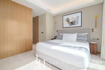 a bedroom with a large white bed in a room at LUX The Address Opera Downtown Suite in Dubai