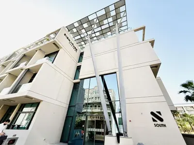 a man walks in front of the sony building at Vserve -Elegant Penthouse Stay in the Heart of JVC in Dubai