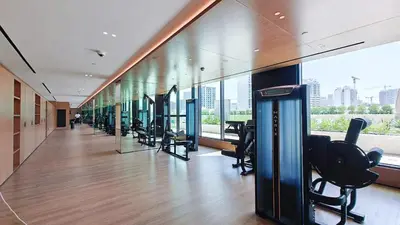 a gym with a row of chairs in a building at Golden Stays - Binghatti Onyx I Brand New 1BR I Modern and Fully Furnished in Dubai