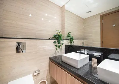 a bathroom with two sinks and a mirror at Luxury 2 BR Missoni Building Canal & Pool View in Dubai