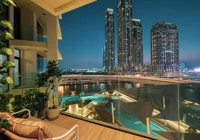 a view of a city skyline from a building with a swimming pool at Luxury 2 BR Missoni Building Canal & Pool View in Dubai