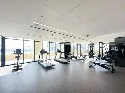 a gym with treadmills and exercise equipment in a building at Luxury 2 BR Missoni Building Canal & Pool View in Dubai