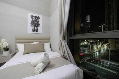 a bedroom with a white bed with a window at Luxurious Crown - Downtown - Fountains View in Dubai