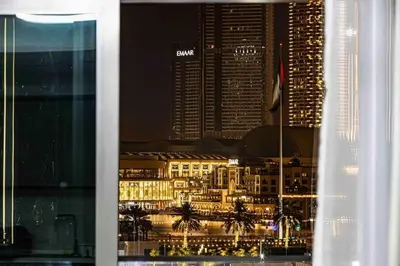 a view of a city at night from a window at Luxurious Crown - Downtown - Fountains View in Dubai