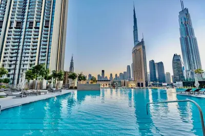 a swimming pool in a city with tall buildings at Seraya Residence 5 - 4BDR - Burj Views - Private Jacuzzi in Dubai