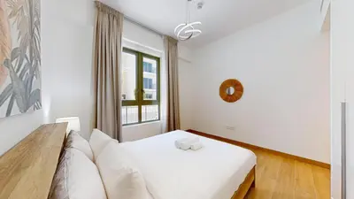 a living room with a couch and a window at La Sirene 2 - Magnificient Two Bedroom in La Mer in Dubai