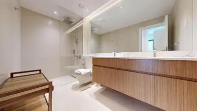 a bathroom with a sink and a toilet and a mirror at La Sirene 2 - Magnificient Two Bedroom in La Mer in Dubai