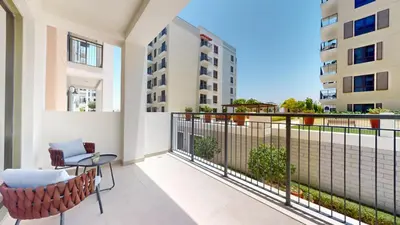 a balcony with a table and chairs in a building at La Sirene 2 - Magnificient Two Bedroom in La Mer in Dubai
