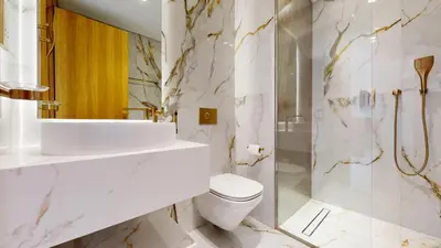 a bathroom with a toilet and a sink and a shower at Elegant - Three Bed Villa in Jumeirah Golf Estate in Dubai
