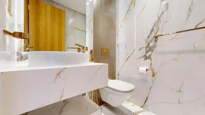 a white bathroom with a sink and a toilet at Elegant - Three Bed Villa in Jumeirah Golf Estate in Dubai