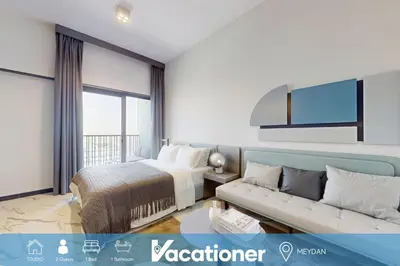 a hotel room with a bed and a couch at Mag Eye 920 - Spacious Studio in Meydan in Dubai