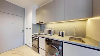 a kitchen with a washer and dryer in it at Mag Eye 920 - Spacious Studio in Meydan in Dubai
