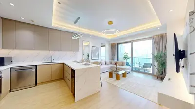 an open kitchen and living room with a couch at Stunning One Bedroom in the Marina in Dubai